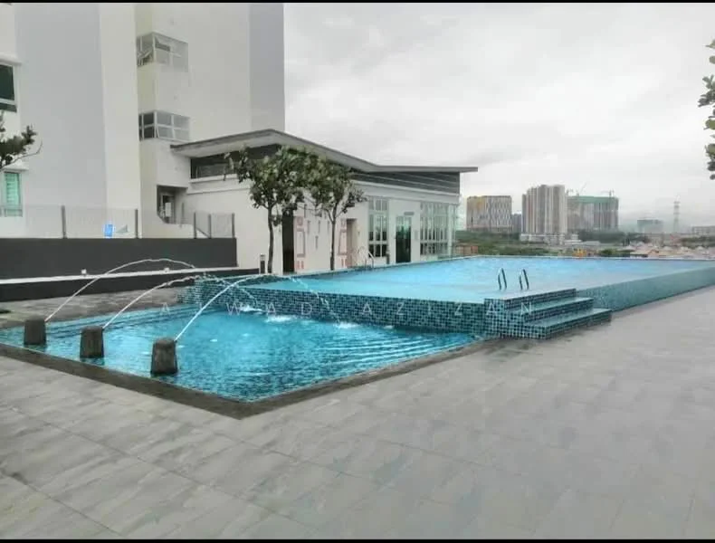 Exterior type: swimming pool deck; features: infinity pool, water features with jets, stone-paved deck, surrounding greenery, modern pool design, glass facade building in background; style: modern.