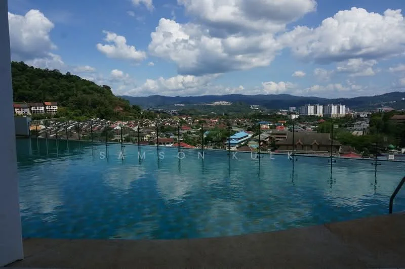 Exterior type: swimming pool deck; features: infinity pool, pool deck with loungers, surrounded by greenery, city skyline view, mountain view, cloudy sky, parking lot visible in the background; style: modern.