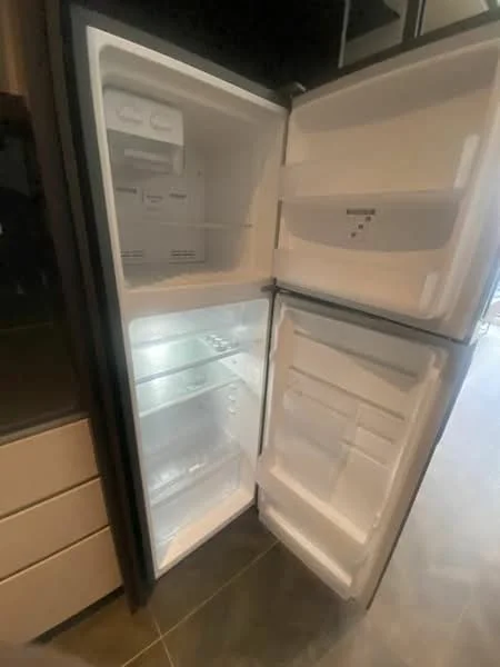 Kitchen features: stainless-steel fridge, double-door fridge, internal shelving, clear storage bins, frost-free design, interior lighting; style: modern.