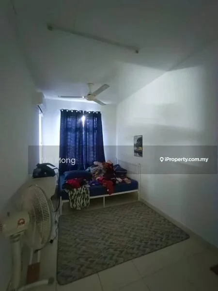 Bedroom features: single bed, blue bedspread, wall-mounted ceiling fan, white painted walls, tiled flooring, window with dark curtains, area rug with geometric pattern, clothes on bed.