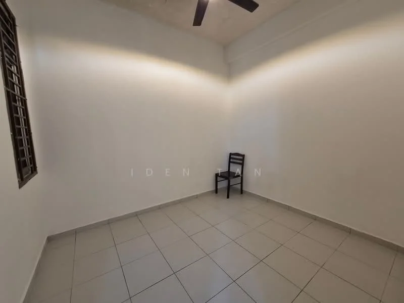Room features: white painted walls, grey tiled flooring, ceiling fan, single chair, window with grille.