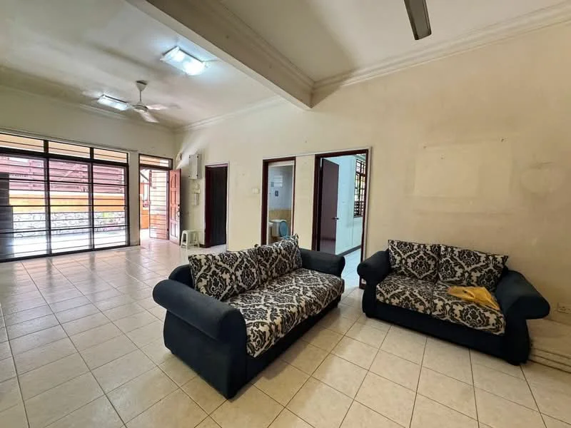 Living features: two fabric sofas in blue and patterned upholstery, tile flooring, white painted walls, ceiling fan, large sliding glass doors, natural light from outside, crown moulding, light fixtures in ceiling.
