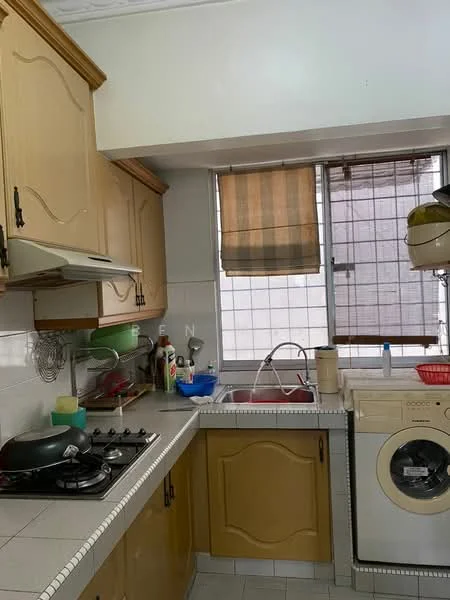 Kitchen features: wooden cabinetry in light brown, white tiled backsplash, grey countertop, stainless-steel sink, chrome pull-down faucet, 4-burner gas hob, built-in oven, freestanding washing machine, window with blinds, kitchen utensils on countertop, dish rack, plastic storage containers.