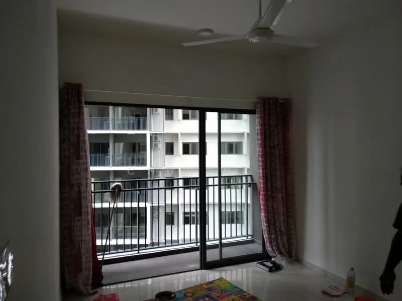 Living features: floor-to-ceiling windows, sliding glass door, curtains in red, white painted walls, ceiling fan, marble flooring, balcony view, decorative area rug; style: modern; view: city.