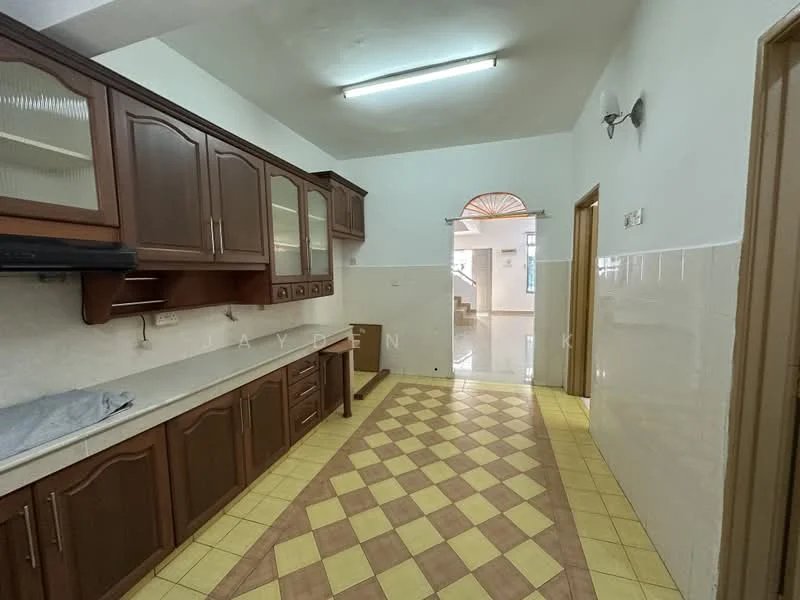 Kitchen features: brown wooden cabinetry, white countertop, single-bowl stainless-steel sink, chrome pull-down faucet, built-in oven, ceramic tile flooring in yellow and brown pattern, wall-mounted hood, wall tiles with white finish, recessed ceiling lights, open layout to adjacent room; style: traditional. Room features: doorway leading to another room, light-colored walls, tile flooring.