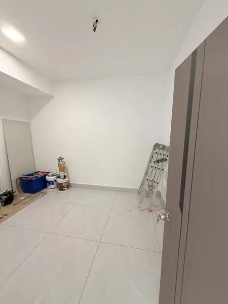 Room features: white painted walls, grey tiled flooring, ceiling light fixture, ladder, paint cans, mirror, unfinished space, no visible furniture.