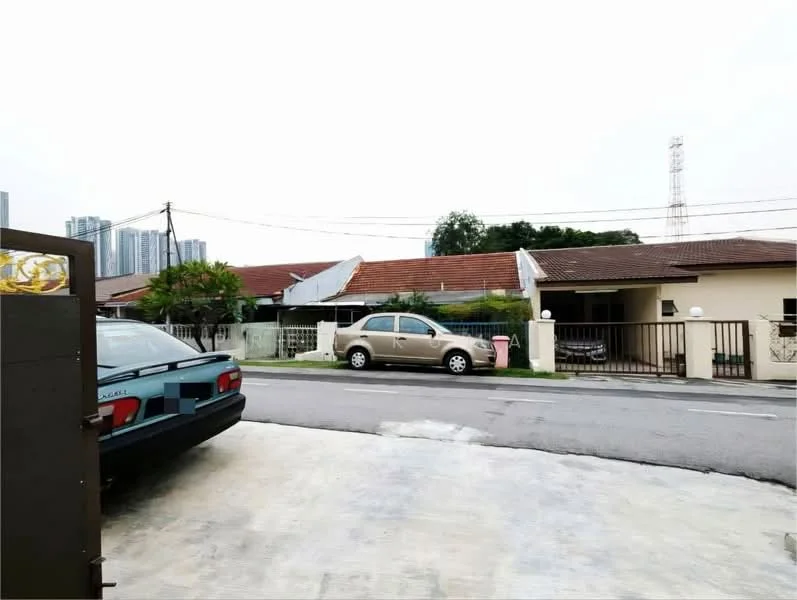 Exterior type: linked terrace house; features: single-storey, red tiled roof, white painted facade, front yard with driveway, manicured lawn, surrounded by mature greenery, street view, parking space for vehicles, visible utility poles, adjacent to residential street; style: traditional.