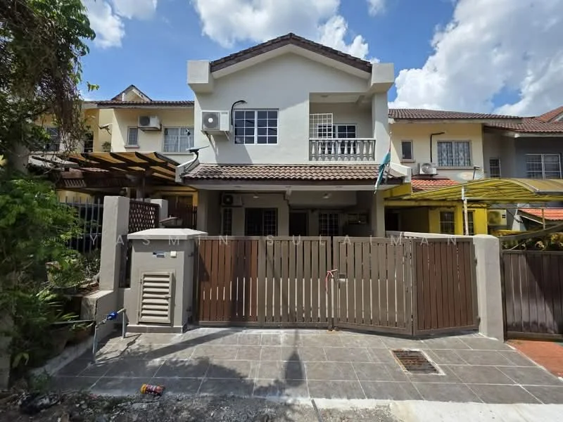 Exterior type: linked terrace house; features: two-storey building, white painted facade, brown tiled roof, front porch with tiled flooring, wooden gate, air conditioning unit visible, manicured landscaping, driveway with interlocking pavers, covered car porch, balcony on the upper floor, windows with grills; style: modern.