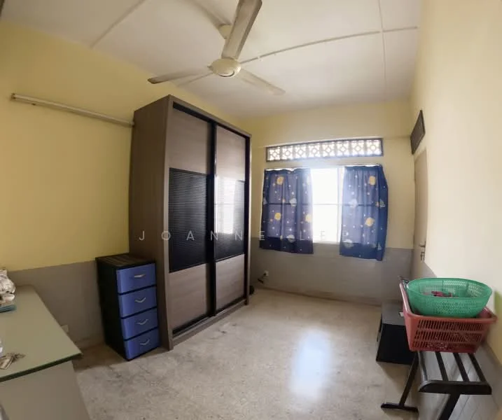 Bedroom features: light yellow painted walls, ceiling fan, window with blue curtains, built-in wardrobe with sliding doors, grey storage drawers, marble flooring, small table with glass top, basket for storage.