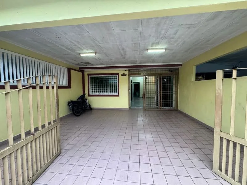 Exterior type: linked terrace house; features: paved flooring, yellow painted walls, metal security grille, two gates, overhead lighting, motorcycle parked, open space, front porch area; style: modern.