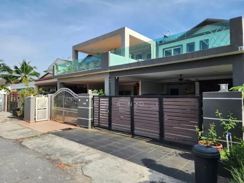 Exterior type: detached bungalow; features: two-storey structure, glass balcony on the upper level, gated entrance with metal gate, paved driveway, manicured lawn, tropical landscaping with palm trees, covered car porch, exposed concrete facade, sliding glass door, modern architectural design; style: modern.