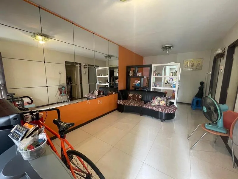 Living features: large wall mirror, orange accent wall, black leather sofa, striped fabric cushions, white shelving unit, decorative items on shelves, tile flooring, ceiling light fixture, bicycle, fan, blue chair; style: modern.