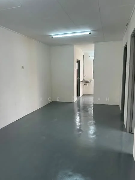 Room features: grey polished concrete flooring, white painted walls, fluorescent ceiling lights, doorway leading to another room, doorway leading to a kitchen area, no visible windows, simple ceiling design; style: minimalist.