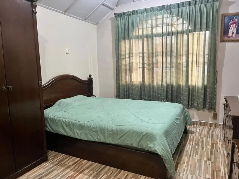 Bedroom features: queen-size bed with green bedding, wooden bed frame, wooden wardrobe, wooden dresser, green patterned curtains, large arched window, laminate flooring, painted walls in light color, ceiling with sloped design; style: traditional.