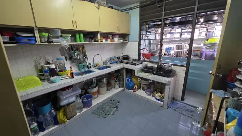Kitchen features: white cabinetry, stainless-steel sink, chrome faucet, gas stove, white tiled backsplash, blue tiled flooring, open shelving, various kitchen utensils, multiple plastic containers, wall-mounted racks for utensils, window for natural light, cleaning supplies on countertop; style: functional.