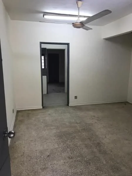 Room features: plain white walls, concrete flooring, ceiling fan, single light fixture, doorway leading to another room, window opening, neutral color scheme; style: minimalist.
