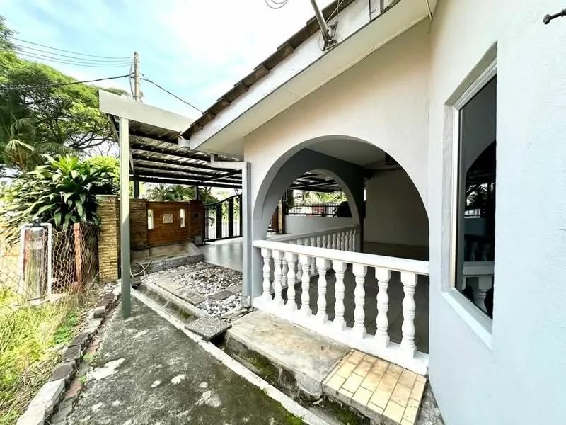 Exterior features: white painted facade, arched entrance, balustrade, concrete flooring, covered walkway, landscaped garden area, fenced perimeter, outdoor space with gravel, roof overhang; style: modern.