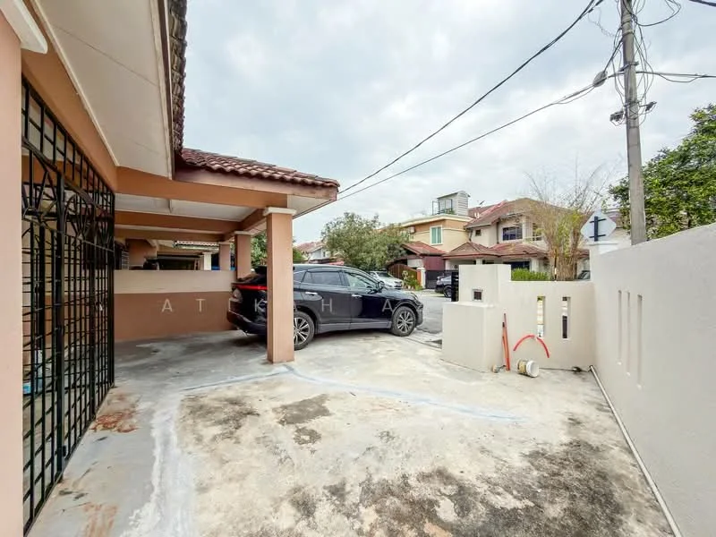Exterior type: linked terrace house; features: car porch with concrete flooring, single-storey structure, fenced perimeter, manicured landscaping, paved driveway, visible neighboring houses, overhead power lines, gated entry; style: modern.