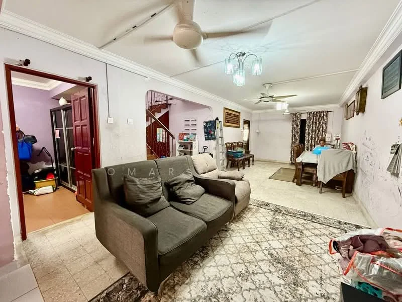 Living features: grey fabric sofa, area rug with geometric pattern, ceiling fan, chandelier, white painted walls, tile flooring, wall-mounted decor, dining table with chairs, wooden staircase in background; style: traditional. Room features: wooden door, storage area with bags, tile flooring, white walls.