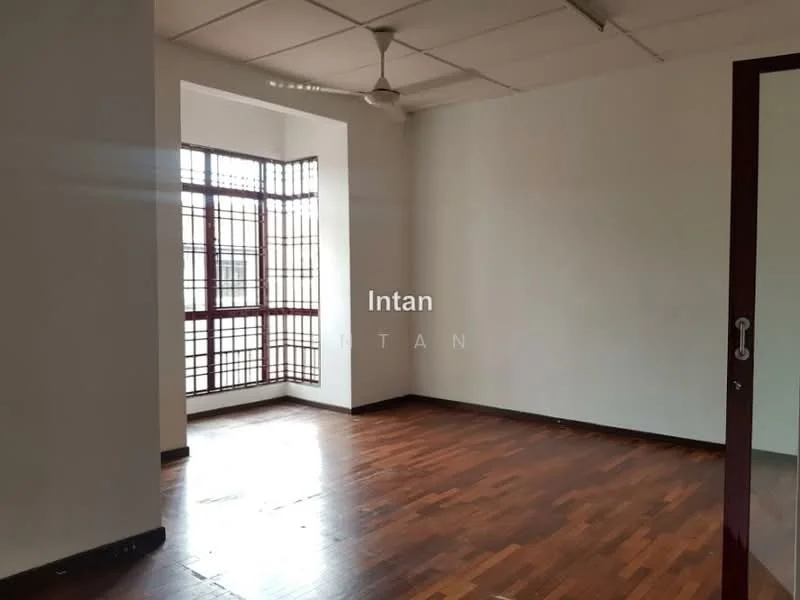 Room features: wooden flooring, white painted walls, ceiling fan, large window with grid pattern, natural light, corner room, no visible furniture.