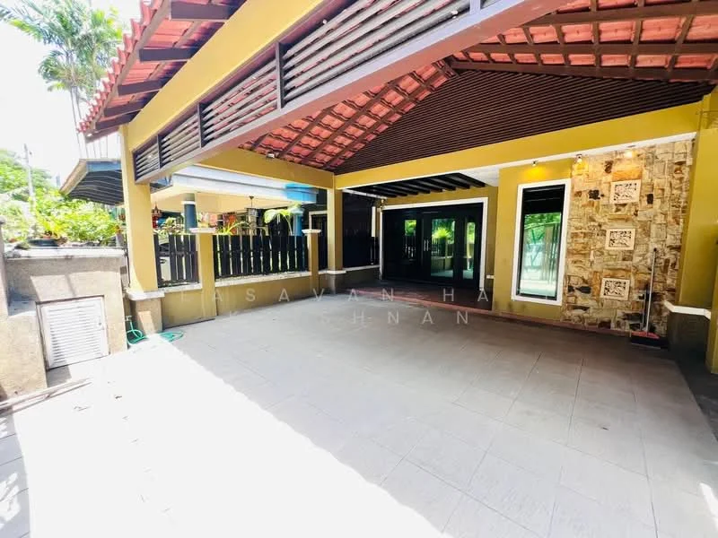 Room features: yellow painted walls, exposed brick feature wall, sliding glass doors, terracotta tile flooring, wooden ceiling beams, outdoor patio area, potted plants, large windows, open layout; style: modern; view: garden.