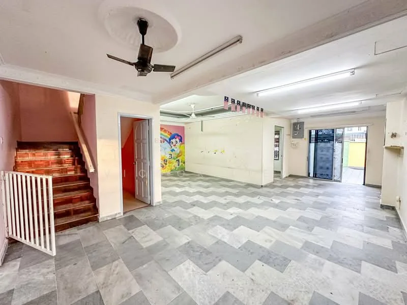 Room features: grey and white chevron patterned flooring, white painted walls, ceiling fan, staircase with wooden steps, wall with colorful mural, fluorescent lighting, open layout, doorway leading to outdoor area, window with security bars, built-in shelving, empty wall space for potential decor; style: modern.
