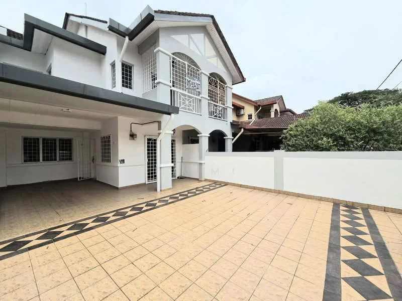 Exterior type: semi-detached house; features: white painted facade, tiled flooring in driveway, decorative tile pattern on driveway, arched windows, gated entrance, manicured greenery, covered porch area, two-storey structure; style: traditional.