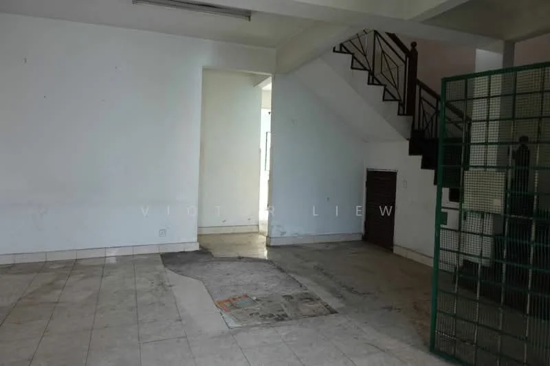 Room features: white painted walls, tile flooring, staircase with wooden railing, doorway leading to another room, corner with wall-mounted features, exposed concrete floor in some areas, light fixture on ceiling, open layout.