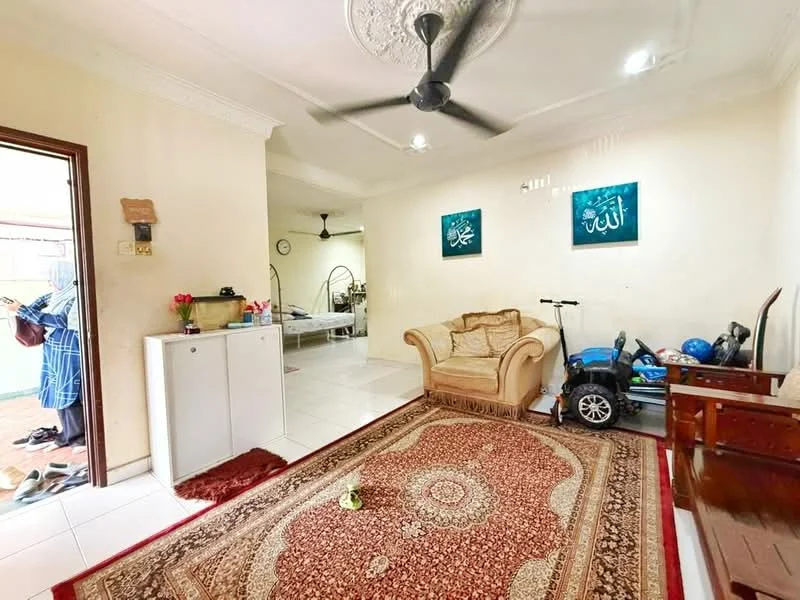 Living features: cream painted walls, white ceiling with crown moulding, 5-blade ceiling fan with light, area rug with intricate pattern, 3-seater fabric sofa in beige, wooden coffee table, decorative wall art, tile flooring, open layout to adjacent room; style: traditional. Room features: white cabinetry, kitchen appliances visible, tile flooring, open layout.
