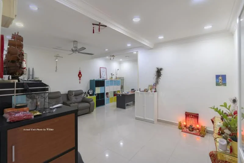 Living features: grey fabric sofa, 3-seater sofa, ceiling fan, recessed LED downlights, white painted walls, glossy tile flooring, decorative wall shelf, small decorative altar, colorful storage cabinets, framed artwork, houseplants in ceramic pots; style: modern.
