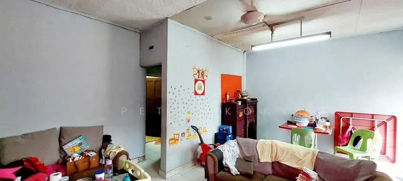Living features: light grey painted walls, white ceiling, ceiling fan, sofa with cushions, coffee table, dining table with chairs, decorative wall art, tile flooring, open doorway to kitchen, various items on furniture.