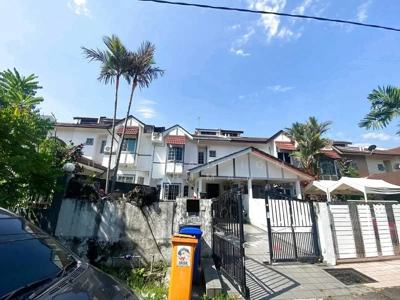 Exterior type: linked terrace house; features: two-storey building, white painted facade, red tiled roof, front garden with palm trees, manicured lawn, gated entrance, black metal gate, driveway with interlocking pavers, air conditioning units visible on facade, outdoor awning, surrounded by greenery; style: modern.