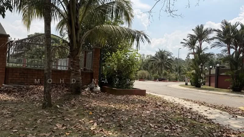 Exterior features: manicured lawn, mature trees, paved walkway, brick wall, gated entrance, surrounded by greenery; style: tropical-modern.