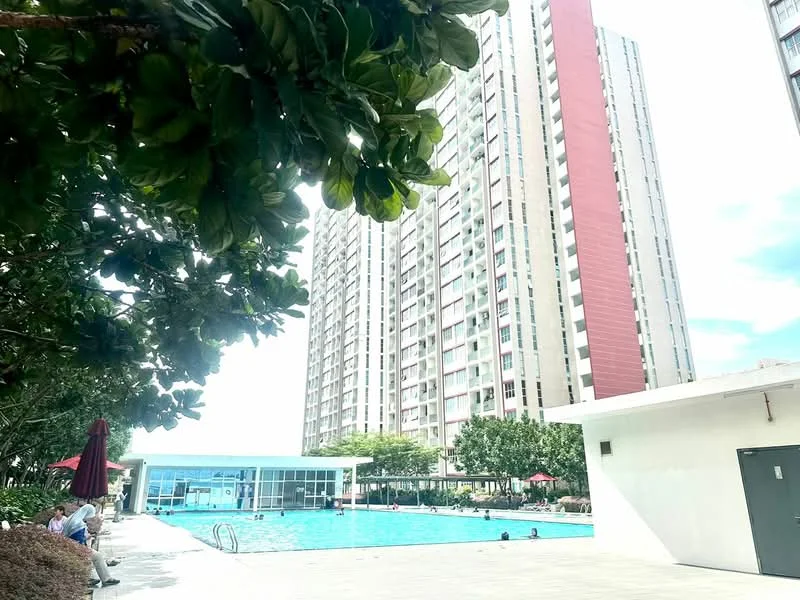 Exterior type: high-rise condominium; features: swimming pool, pool deck with loungers, landscaped garden, manicured lawn, children's playground, outdoor dining pavilion, multiple storey building, glass curtain wall, red accent facade, surrounded by greenery; style: modern.