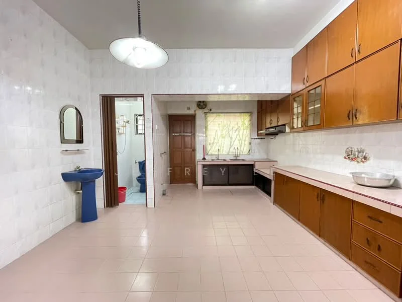 Kitchen features: white tiled walls, pink tiled flooring, brown wooden cabinetry, stainless-steel sink, chrome faucet, built-in oven, cooktop, window with sheer curtains, ceiling light fixture, blue pedestal sink, door leading to hallway, open layout to dining area; style: traditional.