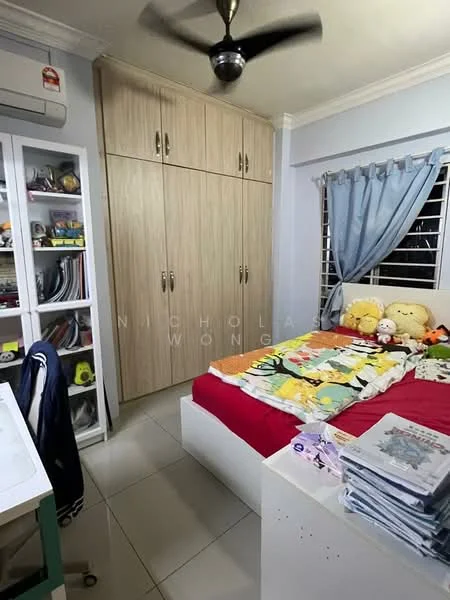 Bedroom features: queen-size bed with red bedding, upholstered headboard, built-in wardrobe with light wood finish, floor-to-ceiling window with sheer curtains, ceiling fan, study desk, decorative pillows, stuffed toys on bed, tile flooring, wall-mounted air conditioning unit; style: modern.