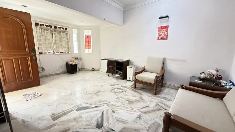 Living features: marble flooring, white painted walls, ceiling with cornice, two armchairs, wooden door, window with grille, small table, air conditioning unit, decorative items on table, light source on ceiling.