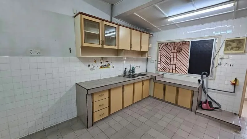 Kitchen features: L-shaped countertop, double-bowl stainless-steel sink, chrome pull-down faucet, cream cabinetry with glass-front upper cabinets, tile backsplash, white tiled walls, grey tiled flooring, window with security grille, built-in storage drawers, vacuum cleaner visible.