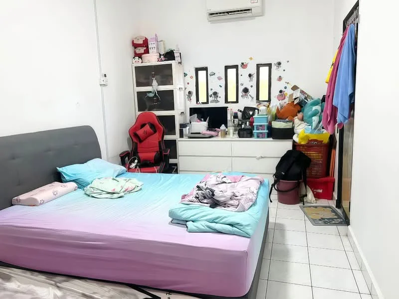 Bedroom features: queen-size bed with grey upholstered headboard, light blue bed linens, white wall paint, white tiled flooring, 1 wall-mounted split AC unit, desk with multiple storage boxes, black office chair, 3 mirrors on the wall, clothes hanging on a rack, decorative wall stickers, various storage containers, area rug at the entrance.