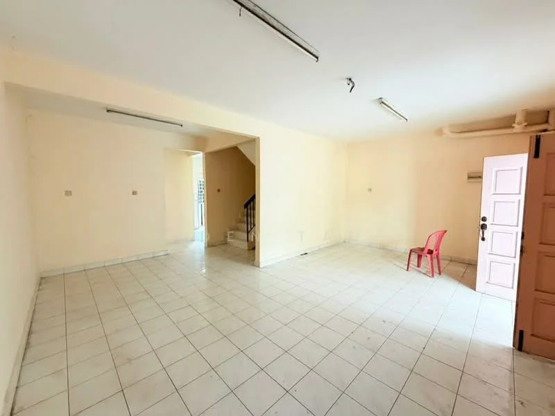 Room features: cream painted walls, white tiled flooring, staircase visible, single red plastic chair, ceiling lights, doorway leading outside, windows with no treatments.
