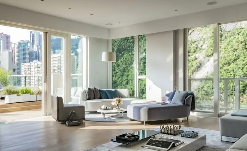 Living features: floor-to-ceiling windows, grey sectional sofa, light grey armchair, coffee table, area rug, decorative vase with flowers, wall-mounted light fixture, wooden flooring, mountain view, outdoor terrace with planters; style: modern; view: mountain.