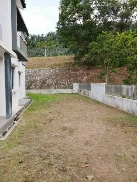 Exterior features: grass lawn, fenced perimeter, retaining wall, landscaped hillside, concrete pathway, exterior wall of building, single-storey structure, surrounding greenery; style: modern.