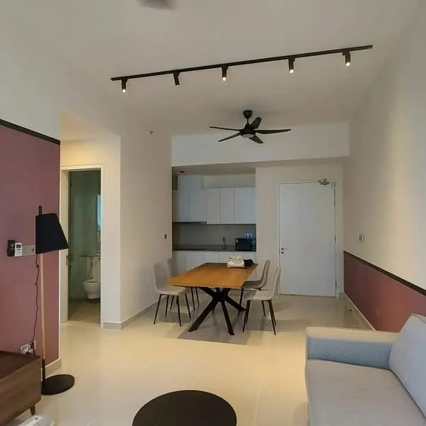 Living features: 3-blade ceiling fan, track lighting, grey fabric sofa, dining table with 4 chairs, white painted walls, accent wall in burgundy, tile flooring, open kitchen layout, wall-mounted intercom, floor-to-ceiling windows, door leading to bathroom, decorative wall clock; style: modern.