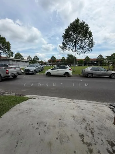 Exterior features: manicured lawn, mature trees, paved driveway, multiple parked cars, residential buildings in background, cloudy sky.