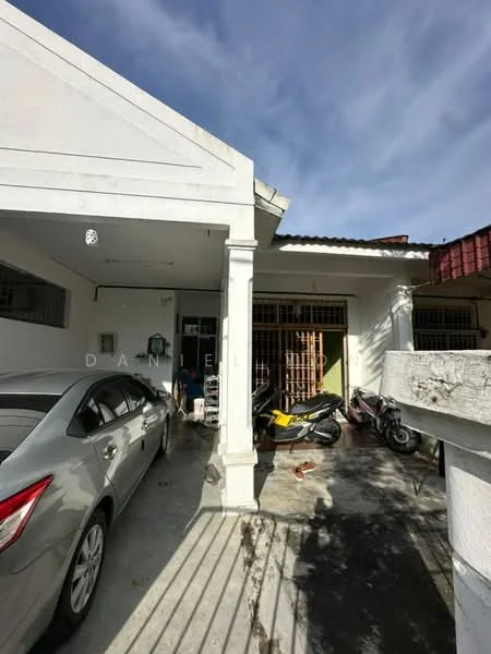 Exterior type: linked terrace house; features: white painted facade, single-storey, flat roof, driveway with interlocking pavers, manicured lawn, front porch, visible parking area, surrounded by mature greenery; style: modern.