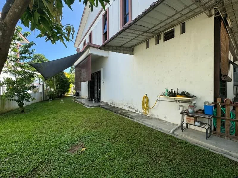 Exterior type: detached bungalow; features: manicured lawn, garden area, concrete pathway, exterior wall with white paint, awning for shade, outdoor storage area with shelves, water hose, outdoor sink, surrounding greenery, fence enclosing the property; style: modern.