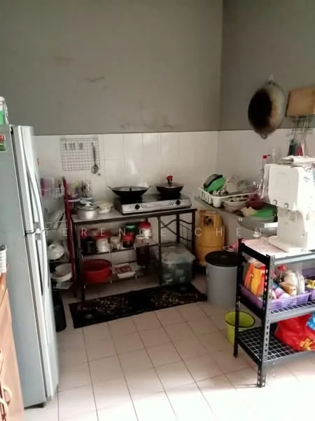 Kitchen features: stainless-steel fridge, metal cooking stove with two burners, kitchen countertop, white tiled backsplash, white wall tiles, grey painted walls, open shelving, various kitchen utensils, plastic storage containers, black metal shelving unit, sink with faucet, floor tiles, cooking pots, dish rack, garbage bin.