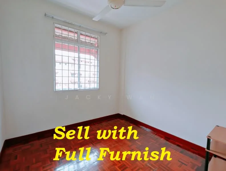 Room features: wooden flooring, white painted walls, ceiling fan, grid-patterned window, natural light from window, corner desk, empty space, no visible furniture.