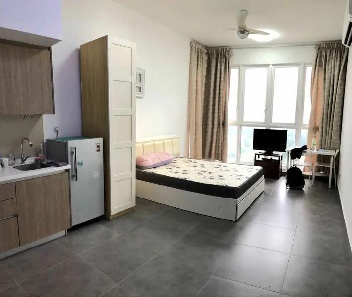 Room features: grey tiled flooring, white painted walls, ceiling fan, large windows with city view, double bed with upholstered headboard, fridge, kitchenette with sink and cabinetry, TV console with wall-mounted TV, curtains, study desk, chair; style: modern; view: city.