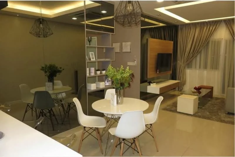 Dining features: round dining table, 4 white dining chairs, decorative vase with flowers, mirrored wall, recessed ceiling lights, grey accent wall, light-coloured flooring, area rug with geometric pattern, wall-mounted TV, open shelving unit, curtains, sofa in living area visible; style: modern.